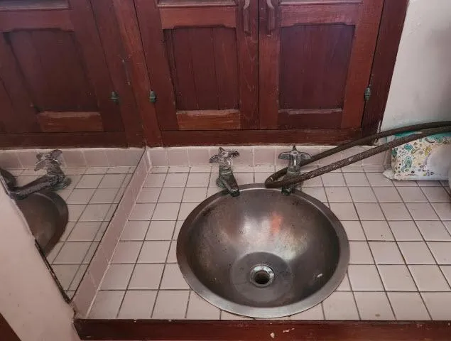 Slide: The Image of Vintage sink with metal basin and wooden cabinets on a 1978 Hardin Voyager 44. - 17
