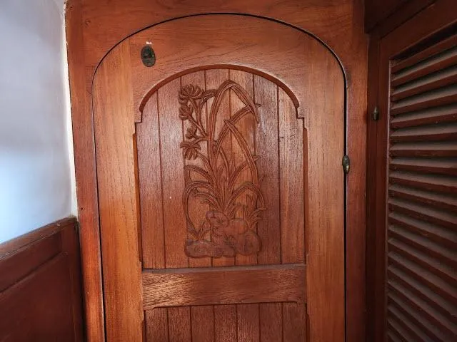 Slide: The Image of Wooden door with floral carving on a 1978 Hardin Voyager 44 sailboat. - 18