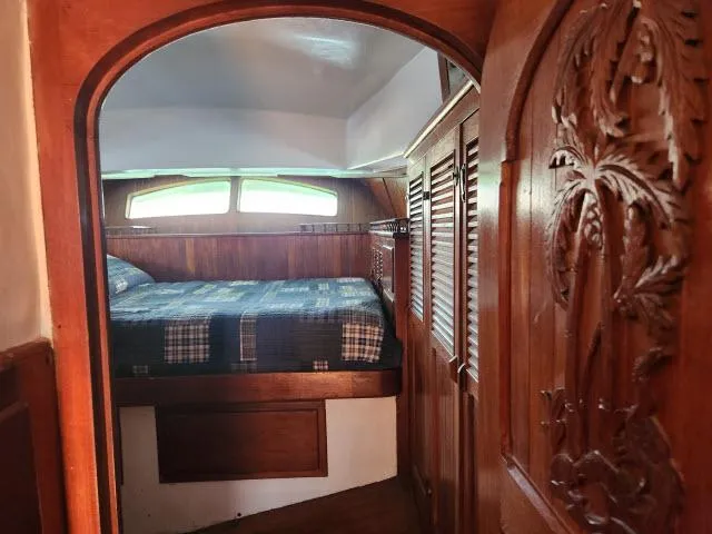Slide: The Image of Cozy cabin interior of 1978 Hardin Voyager 44 sailboat with wood paneling and bed. - 19