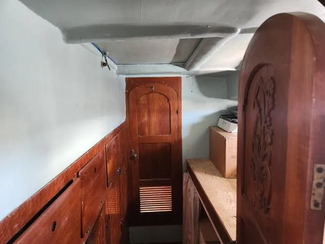 Slide: The Image of Interior of 1978 Hardin Voyager 44 sailboat with wooden cabinetry and door. - 26