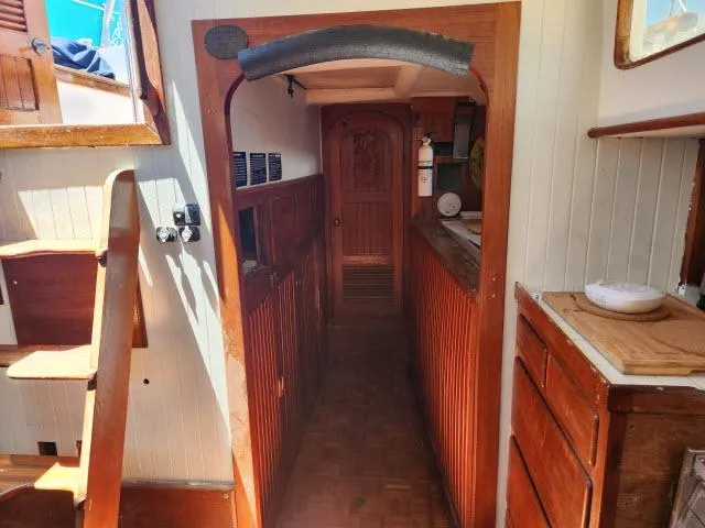 Slide: The Image of Interior of 1978 Hardin Voyager 44 sailboat with wooden cabinetry and stairs. - 27