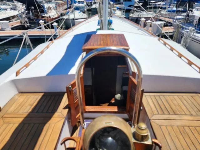 Slide: The Image of 1978 Hardin Voyager 44 sailboat deck with wooden accents, docked at a marina. - 28