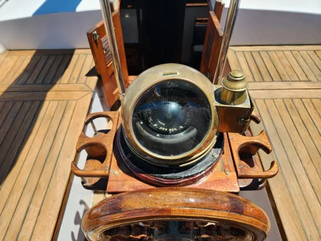 Slide: The Image of Wooden helm and compass on a 1978 Hardin Voyager 44 sailboat. - 29