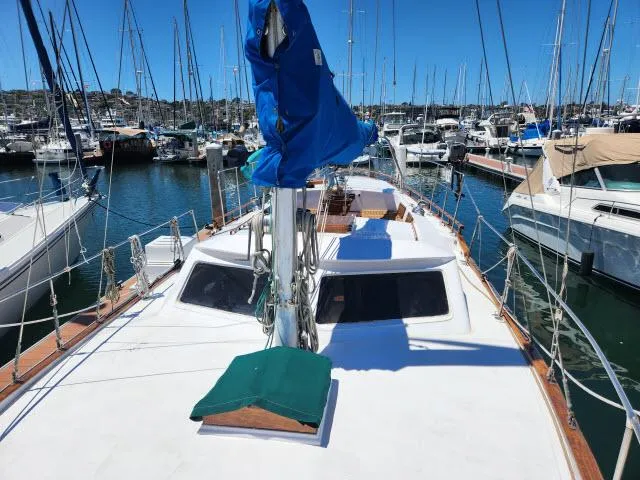 Slide: The Image of 1978 Hardin Voyager 44 sailboat docked in a marina, surrounded by other boats. - 31