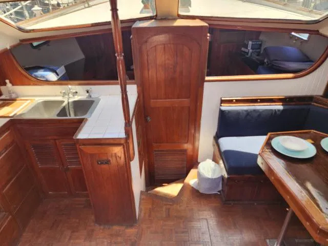 Slide: The Image of 1978 Hardin Voyager 44 interior with wooden cabinetry, sink, and dining area. - 4
