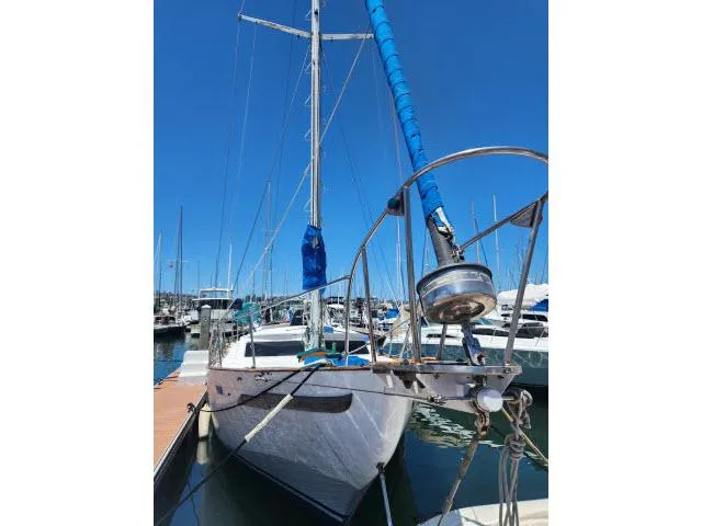 Slide: The Image of 1978 Hardin Voyager 44 sailboat docked in a marina under clear blue skies. - 45