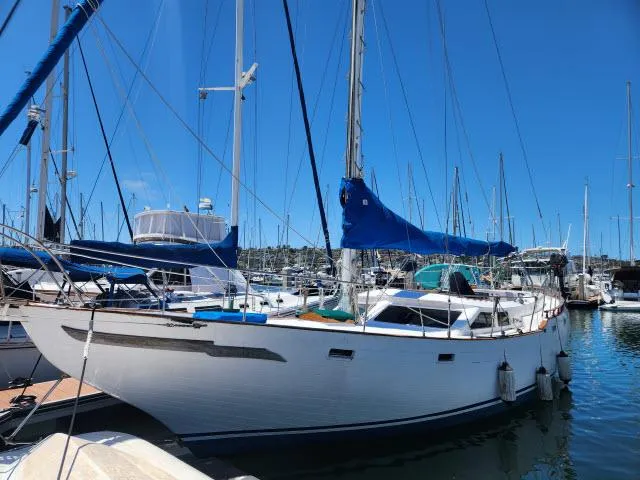 Slide: The Image of 1978 Hardin Voyager 44 sailboat docked in a marina under clear blue skies. - 46