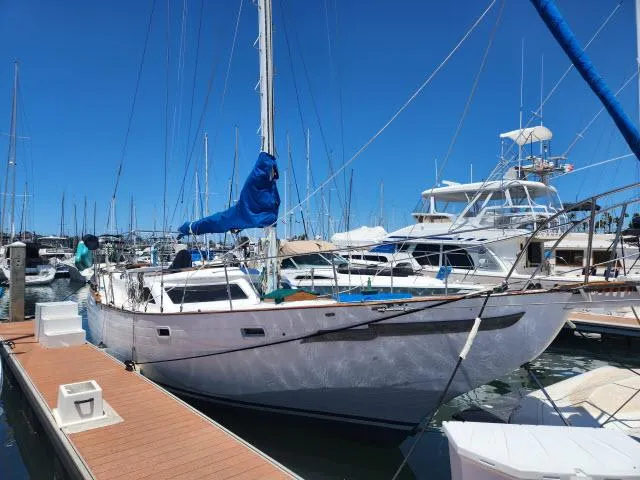 Slide: The Image of 1978 Hardin Voyager 44 sailboat docked at a marina under clear blue skies. - 47