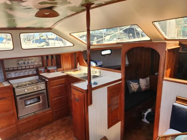 Slide: The Image of 1978 Hardin Voyager 44 yacht interior with wooden cabinetry and cozy seating area. - 6
