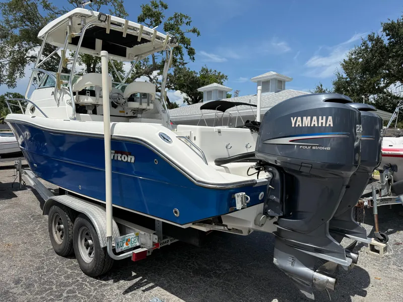 Slide: The Image of 2004 Triton 2690 WA boat with Yamaha outboard motor on a trailer. - 12