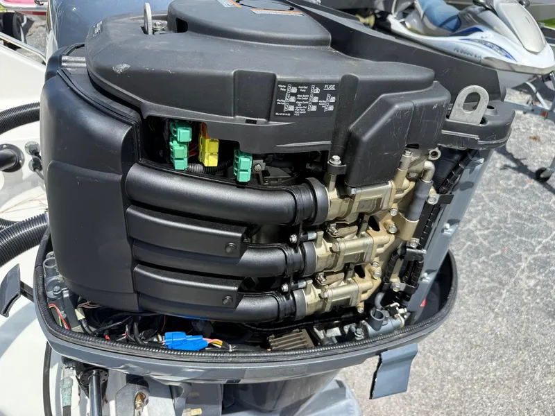 Slide: The Image of Close-up of a 2004 Triton 2690 WA boat engine, showcasing detailed components. - 14