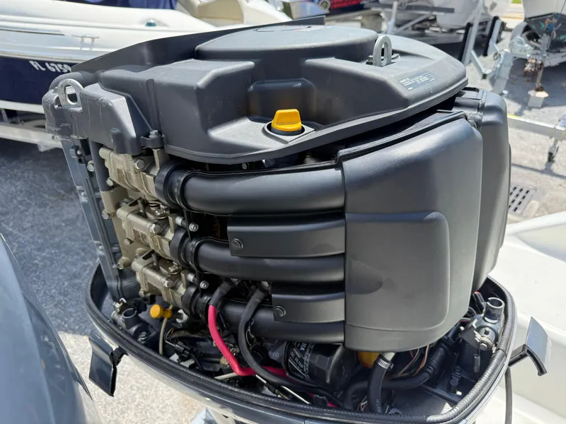 Slide: The Image of Close-up of a 2004 Triton 2690 WA boat engine, showcasing intricate mechanical details. - 15