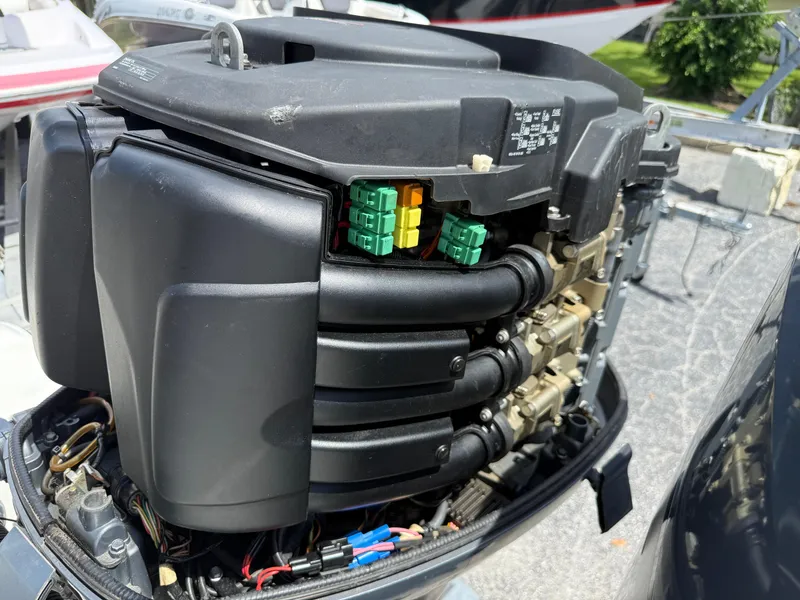 Slide: The Image of Close-up of a 2004 Triton 2690 WA boat engine, showcasing intricate components. - 17