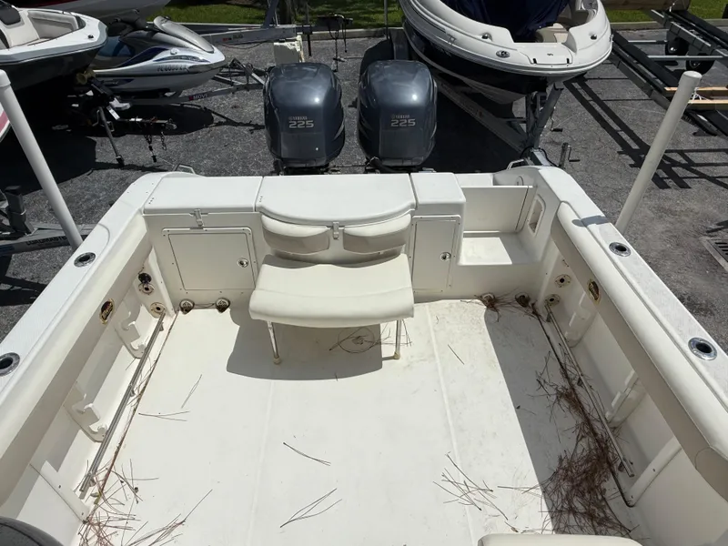 Slide: The Image of 2004 Triton 2690 WA boat interior with seating and storage compartments. - 18