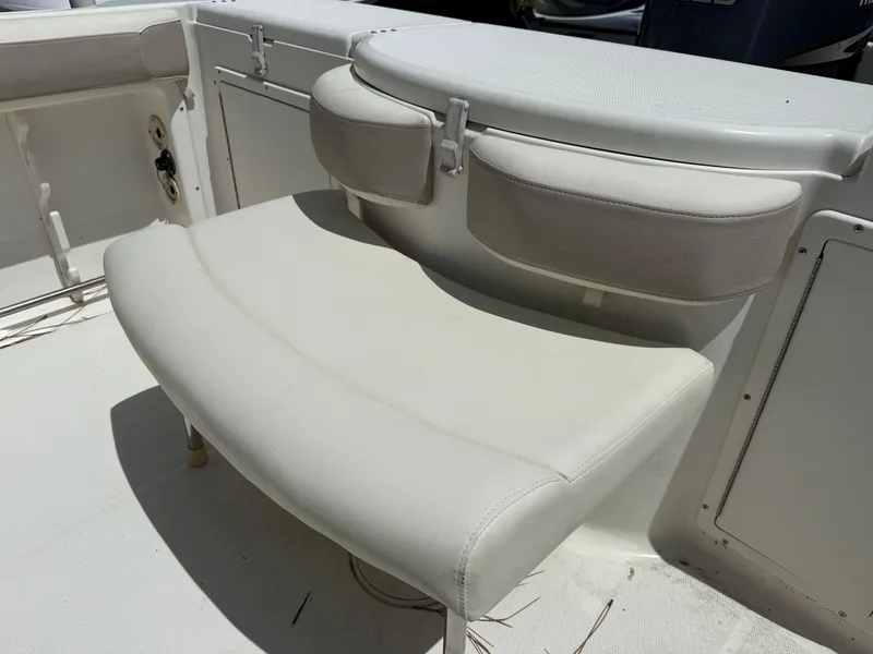 Slide: The Image of 2004 Triton 2690 WA boat interior with white cushioned seating. - 19