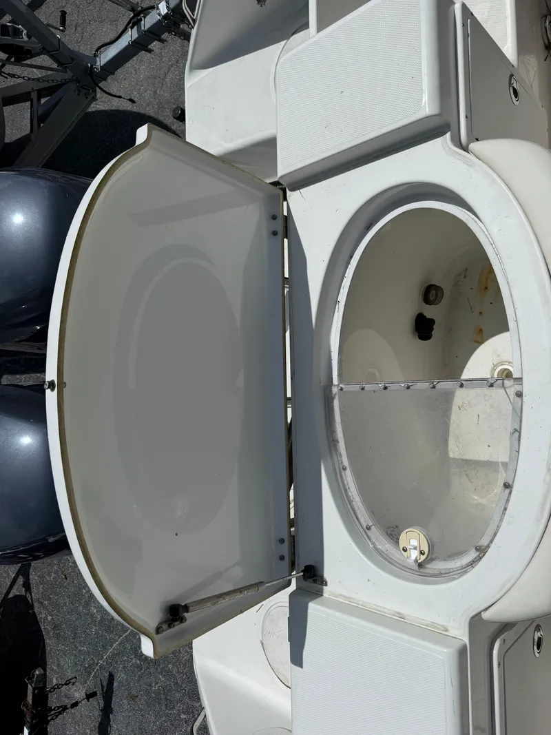 Slide: The Image of Open storage compartment on a 2004 Triton 2690 WA boat. - 20