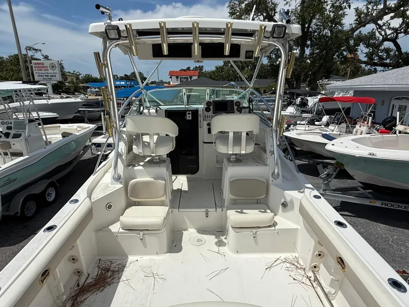 Slide: The Image of 2004 Triton 2690 WA boat interior with dual seats and control panel. - 24