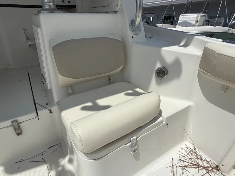 Slide: The Image of 2004 Triton 2690 WA boat interior with cushioned seating and white finish. - 27