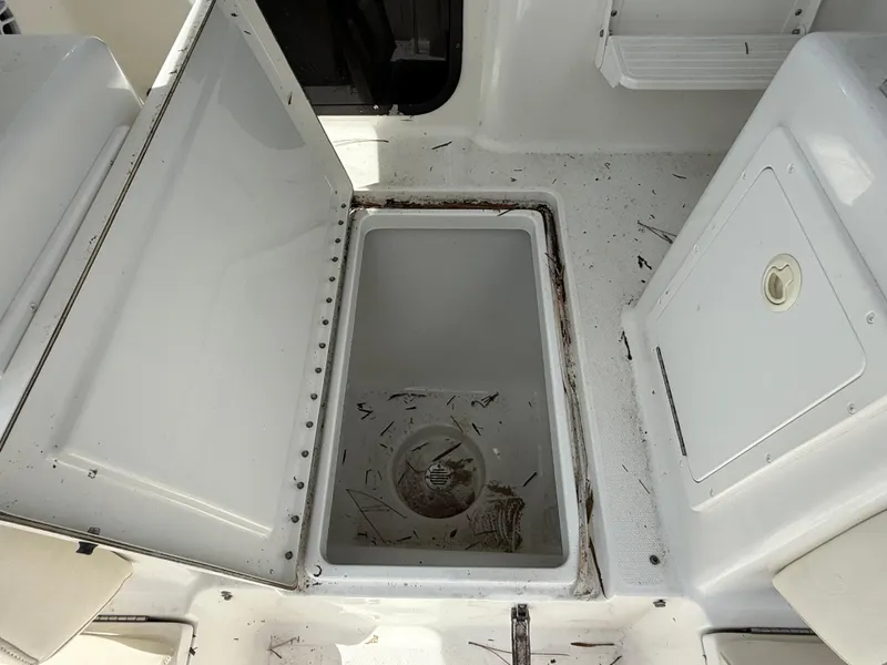 Slide: The Image of Open storage compartment on 2004 Triton 2690 WA boat, showing interior space. - 28