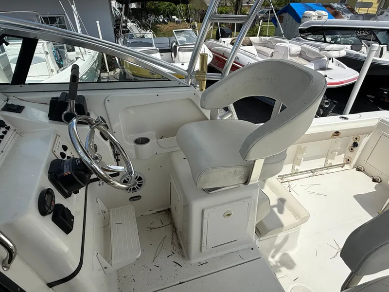 Slide: The Image of 2004 Triton 2690 WA boat cockpit with steering wheel and captain's chair. - 30