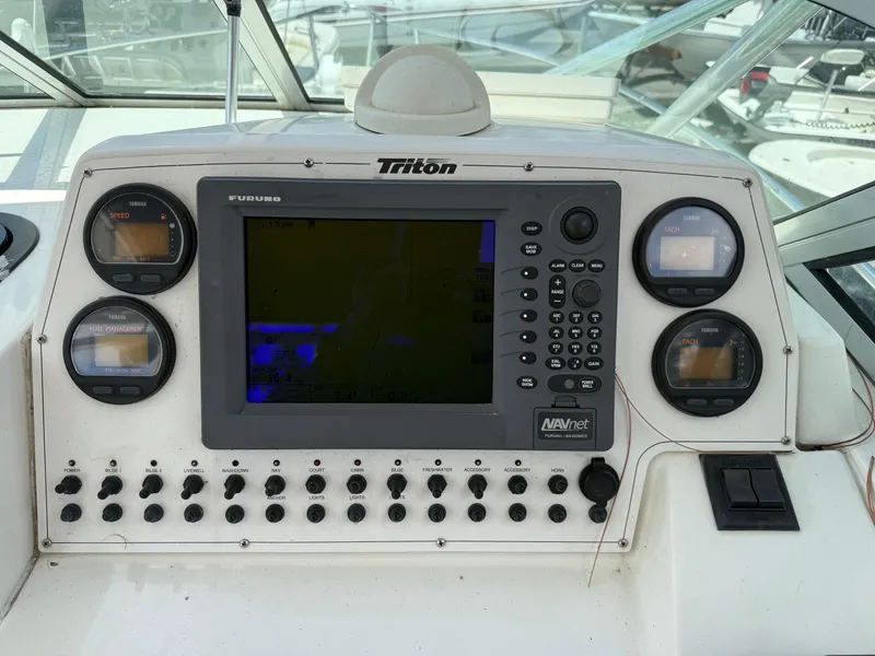 Slide: The Image of Control panel of a 2004 Triton 2690 WA boat with navigation and gauge displays. - 32