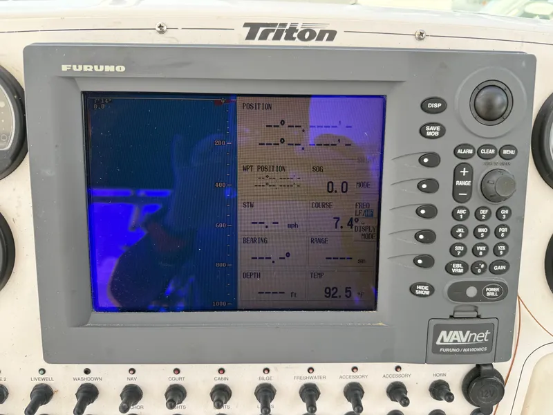 Slide: The Image of 2004 Triton 2690 WA boat dashboard with Furuno NAVnet display and control panel. - 35