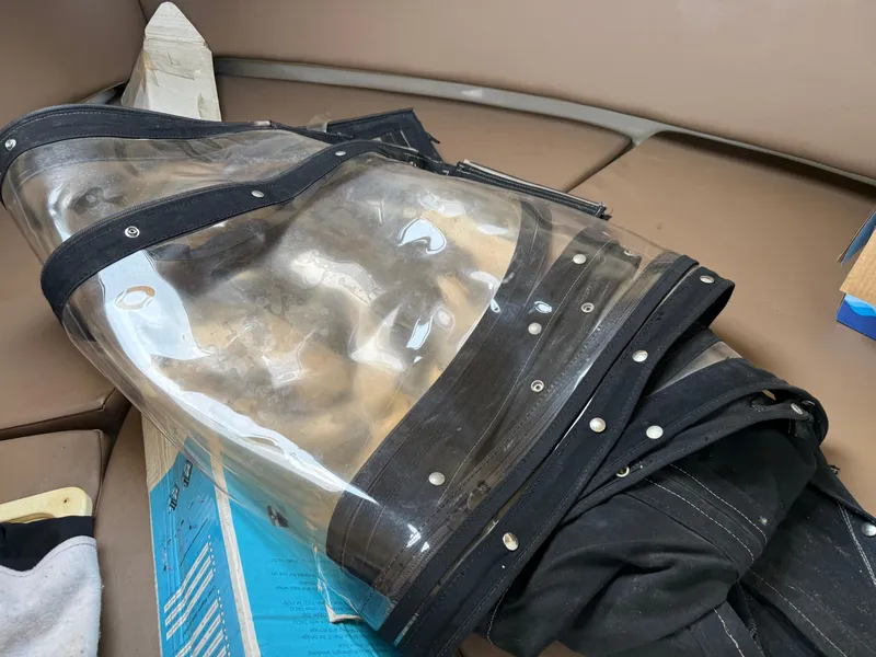 Slide: The Image of Clear boat cover on Triton 2690 WA, 2004 model, with black trim and fasteners. - 37