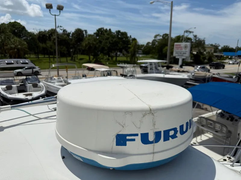 Slide: The Image of Radar equipment on 2004 Triton 2690 WA boat, docked with other vessels in background. - 39
