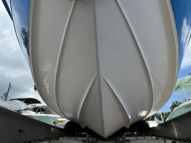 Slide: The Image of Close-up of 2004 Triton 2690 WA boat hull on trailer, under cloudy sky. - 4