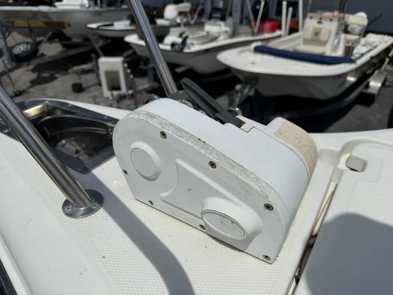 Slide: The Image of 2004 Triton 2690 WA boat detail with white winch on deck. - 40