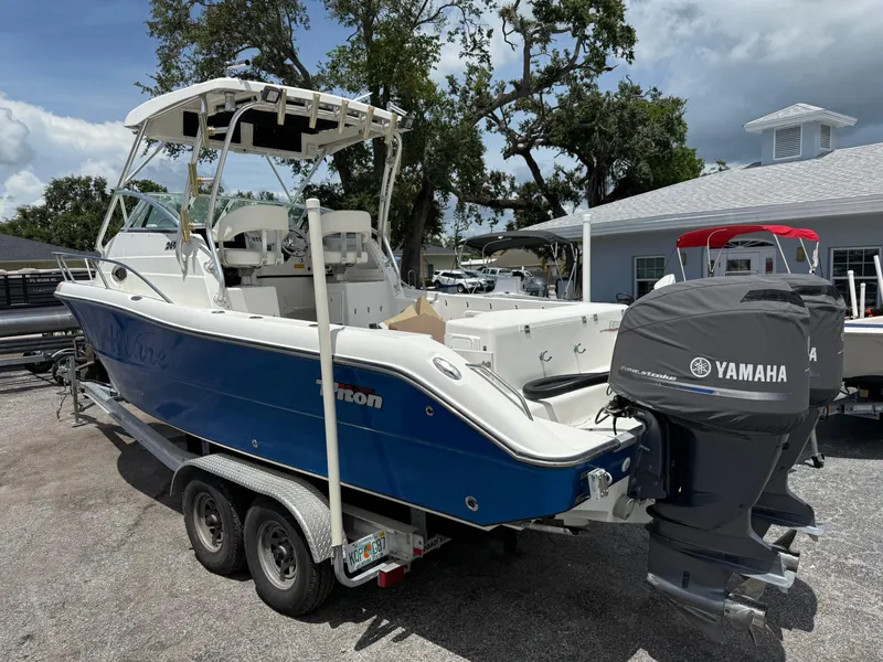 Slide: The Image of 2004 Triton 2690 WA boat with Yamaha engines, parked outdoors on a trailer. - 7