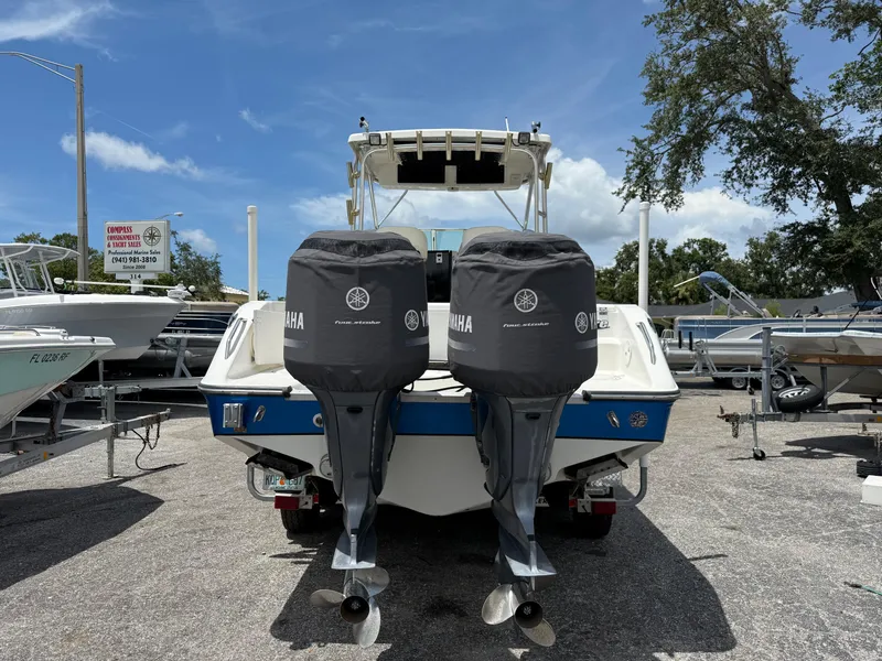 Slide: The Image of 2004 Triton 2690 WA boat with twin Yamaha outboard motors in a marina. - 8