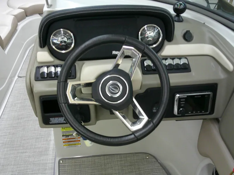 Slide: The Image of 2019 Crownline Eclipse E255 boat interior with steering wheel and seating area. - 18