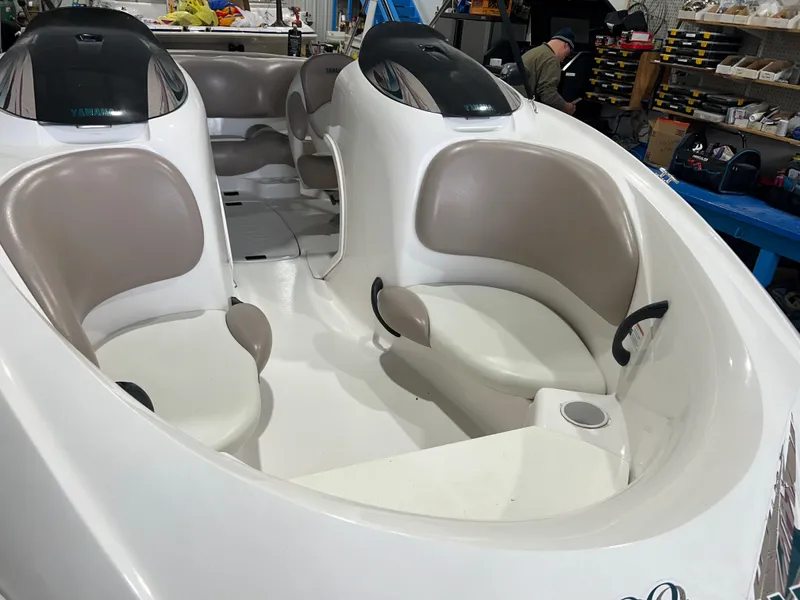 Slide: The Image of 2000 Yamaha Boats LS 2000 interior with beige seating and white deck. - 12