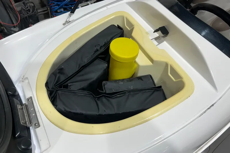 Slide: The Image of Yamaha LS 2000 boat storage compartment with black padding and yellow container, 2000 model. - 17