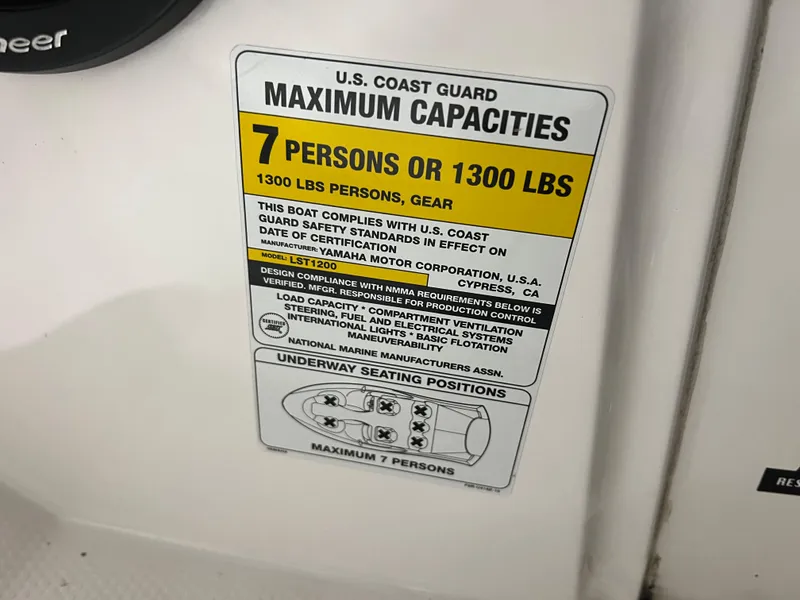 Slide: The Image of U.S. Coast Guard capacity label on 2000 Yamaha Boats LS 2000, max 7 persons or 1300 lbs. - 19