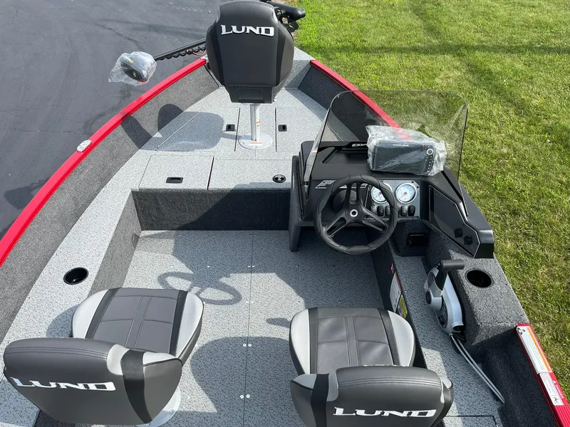 Slide: The Image of 2026 Lund 1650 Angler SS boat interior with steering console and seating. - 10