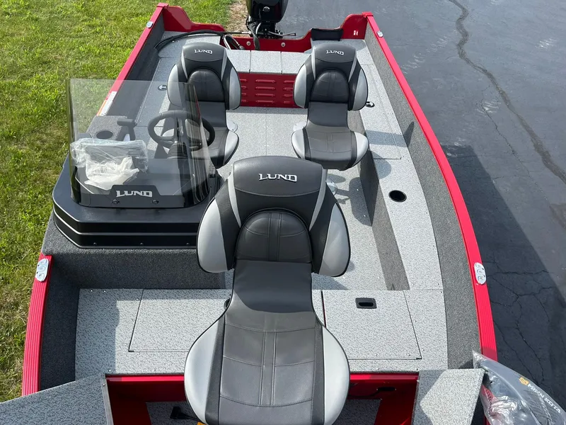 Slide: The Image of 2026 Lund 1650 Angler SS boat interior with three seats and steering console. - 12