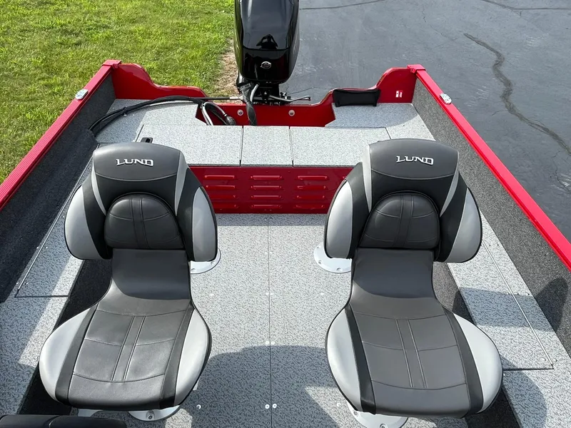 Slide: The Image of 2026 Lund 1650 Angler SS boat interior with two seats and motor. - 13