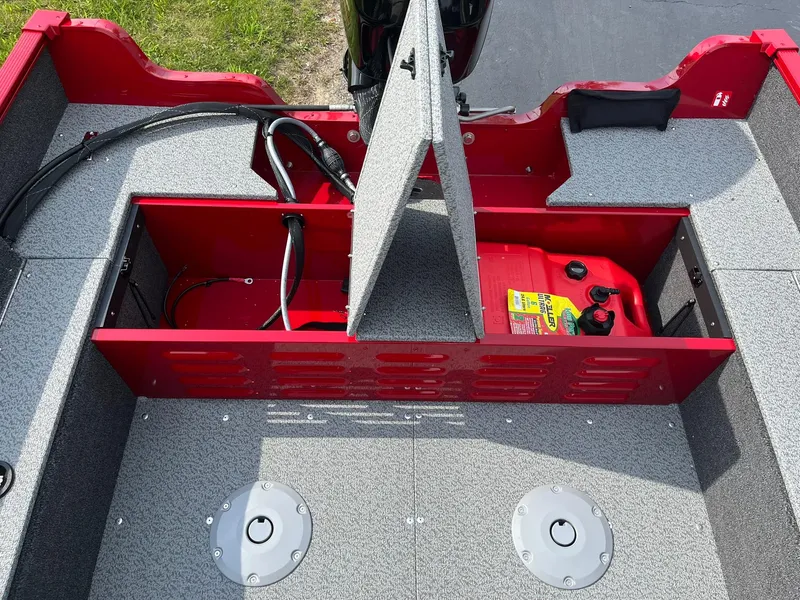 Slide: The Image of 2026 Lund 1650 Angler SS boat interior with open storage compartments and fuel tank. - 16