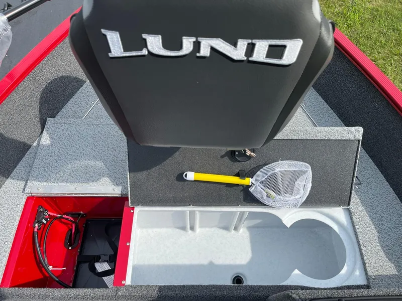 Slide: The Image of 2026 Lund 1650 Angler SS boat interior with storage compartments and fishing net. - 19