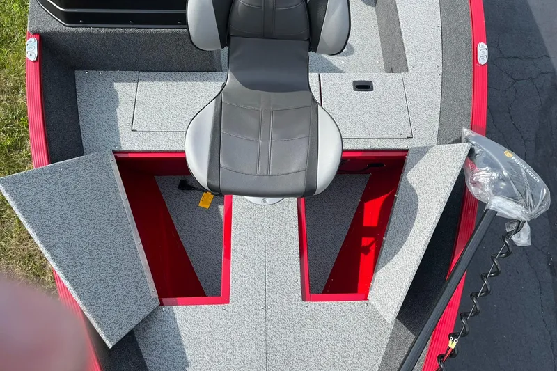 Slide: The Image of 2026 Lund 1650 Angler SS boat interior with open storage compartments and seating. - 21