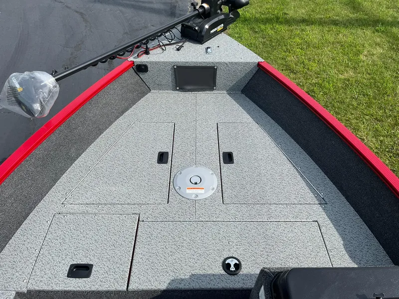 Slide: The Image of 2026 Lund 1650 Angler SS boat deck with storage compartments and trolling motor. - 22