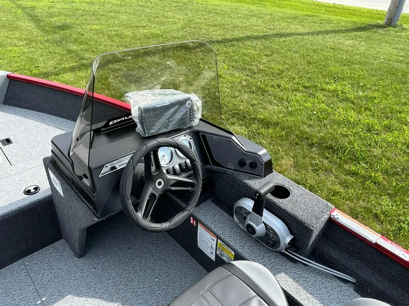 Slide: The Image of 2026 Lund 1650 Angler SS boat interior with steering wheel and control panel. - 24