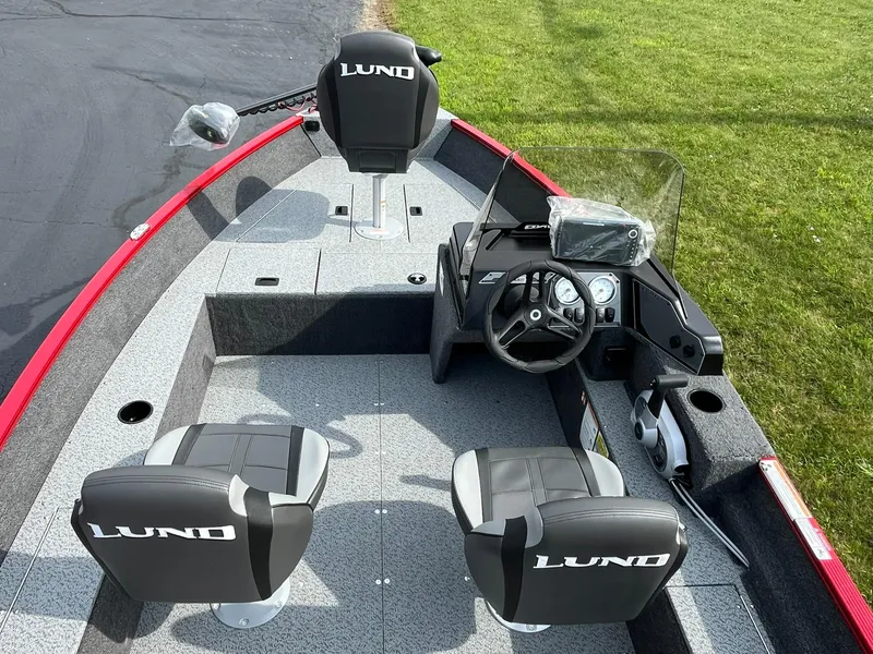 Slide: The Image of 2026 Lund 1650 Angler SS boat interior with steering console and seating. - 6