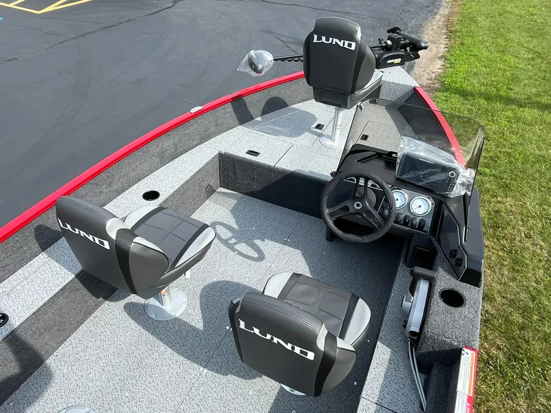 Slide: The Image of 2026 Lund 1650 Angler SS boat interior with seats and steering console. - 7