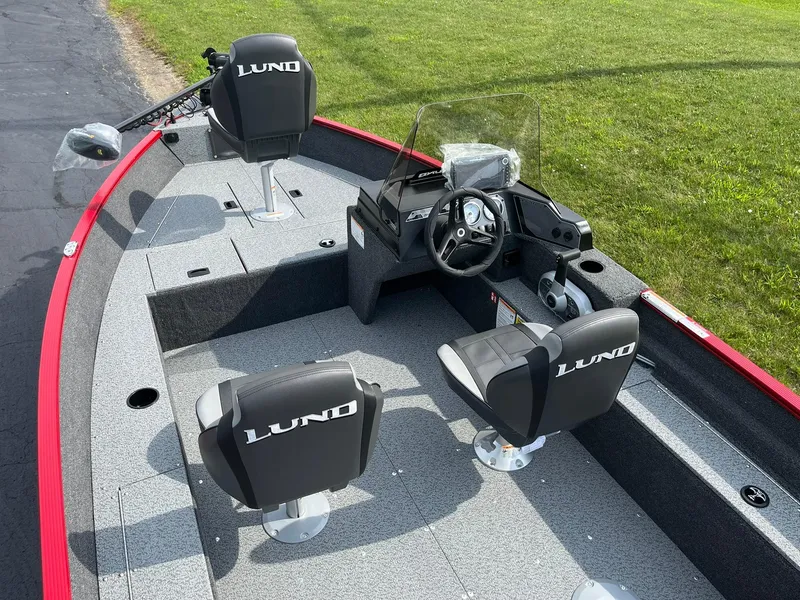Slide: The Image of 2026 Lund 1650 Angler SS boat interior with steering console and seating. - 9