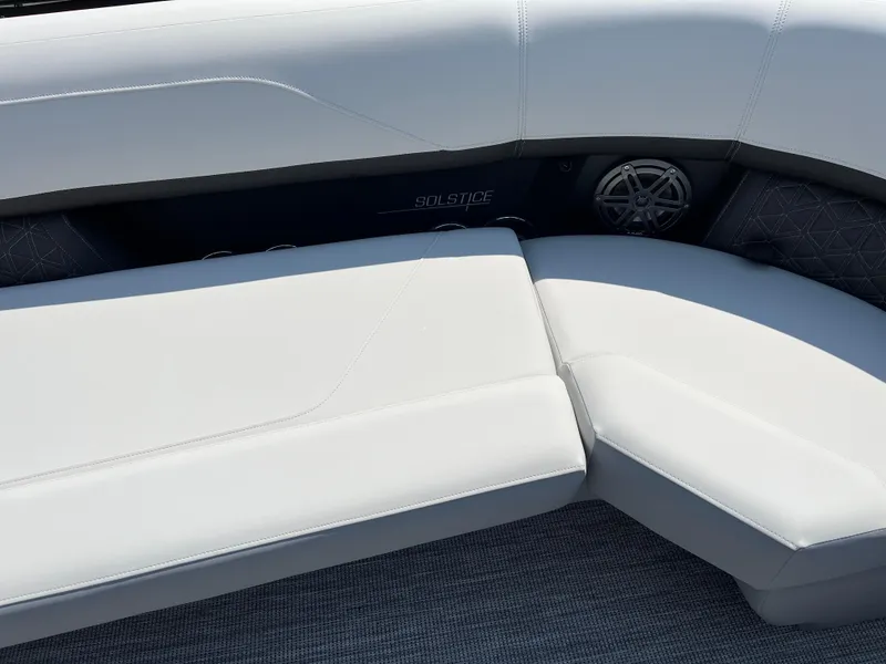 Slide: The Image of 2026 Harris Solstice 250 boat interior with white cushioned seating and speaker detail. - 15
