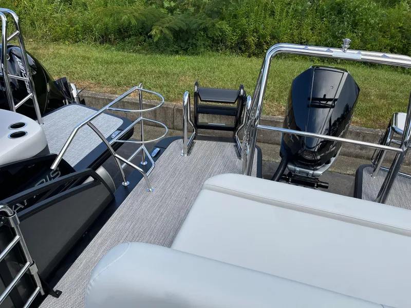Slide: The Image of 2026 Harris Solstice 250 boat deck with motor and seating, featuring sleek design and chrome details. - 18