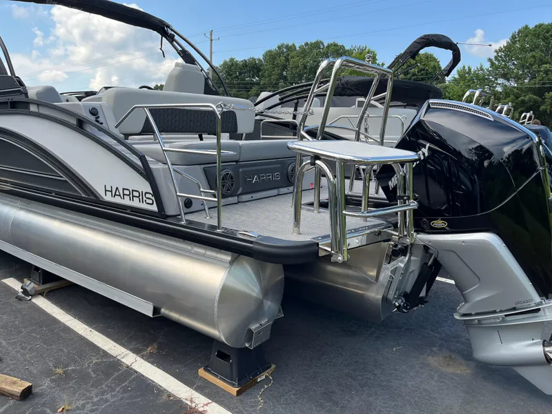 Slide: The Image of 2026 Harris Solstice 250 pontoon boat with sleek design and powerful Mercury engine. - 2